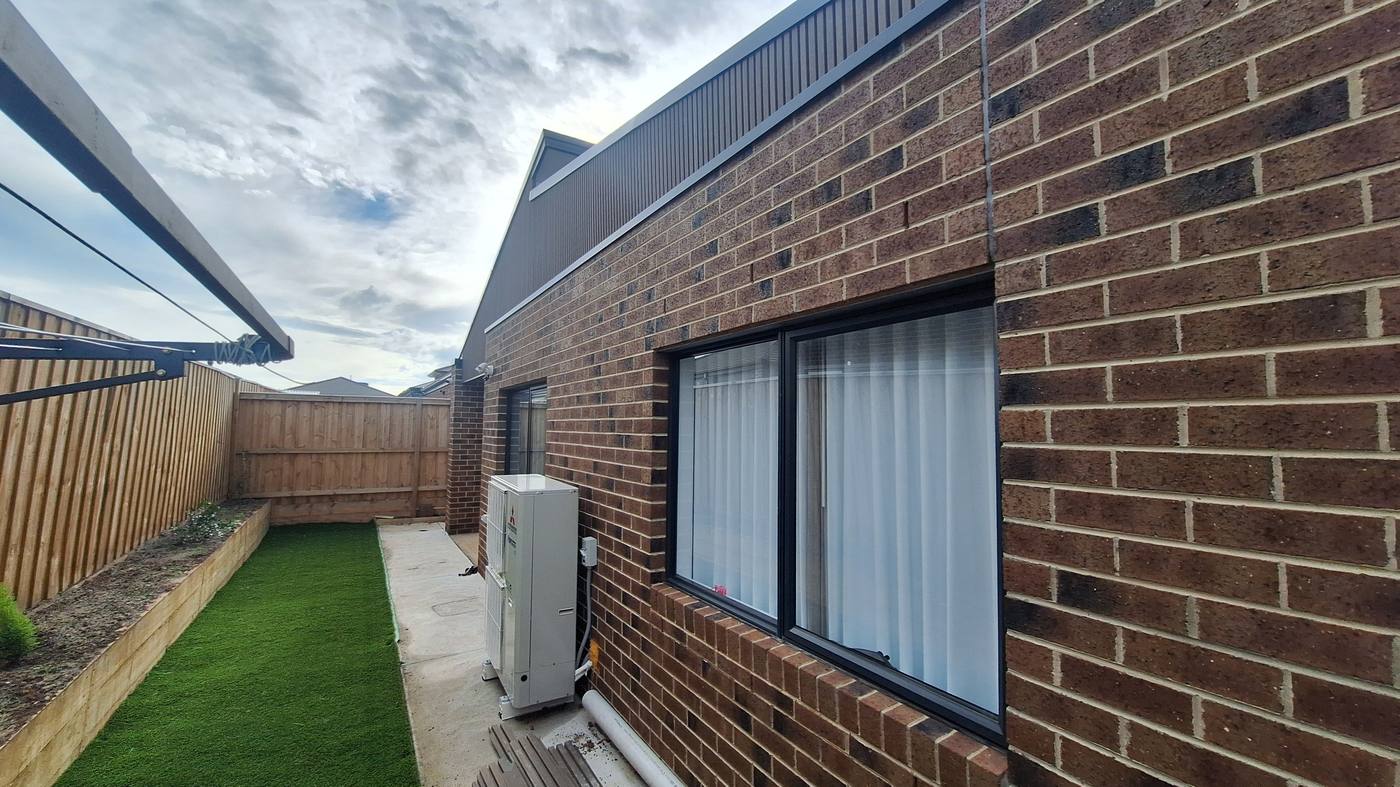 Side elevation — brick and Colorbond, landscaped yard